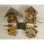 A German made mid Century cuckoo clock, together with a similar example and two miniature Swiss