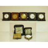 A collection of nine travel clocks, one presented to Miss E Alexander, secretary of the Bradford