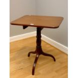 A mahogany tilt top side table, turned central pedestal on three sprayed legs. 64cm x 52cm.