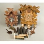 A Swiss made mid Century cuckoo clock together with a smaller example. (2)