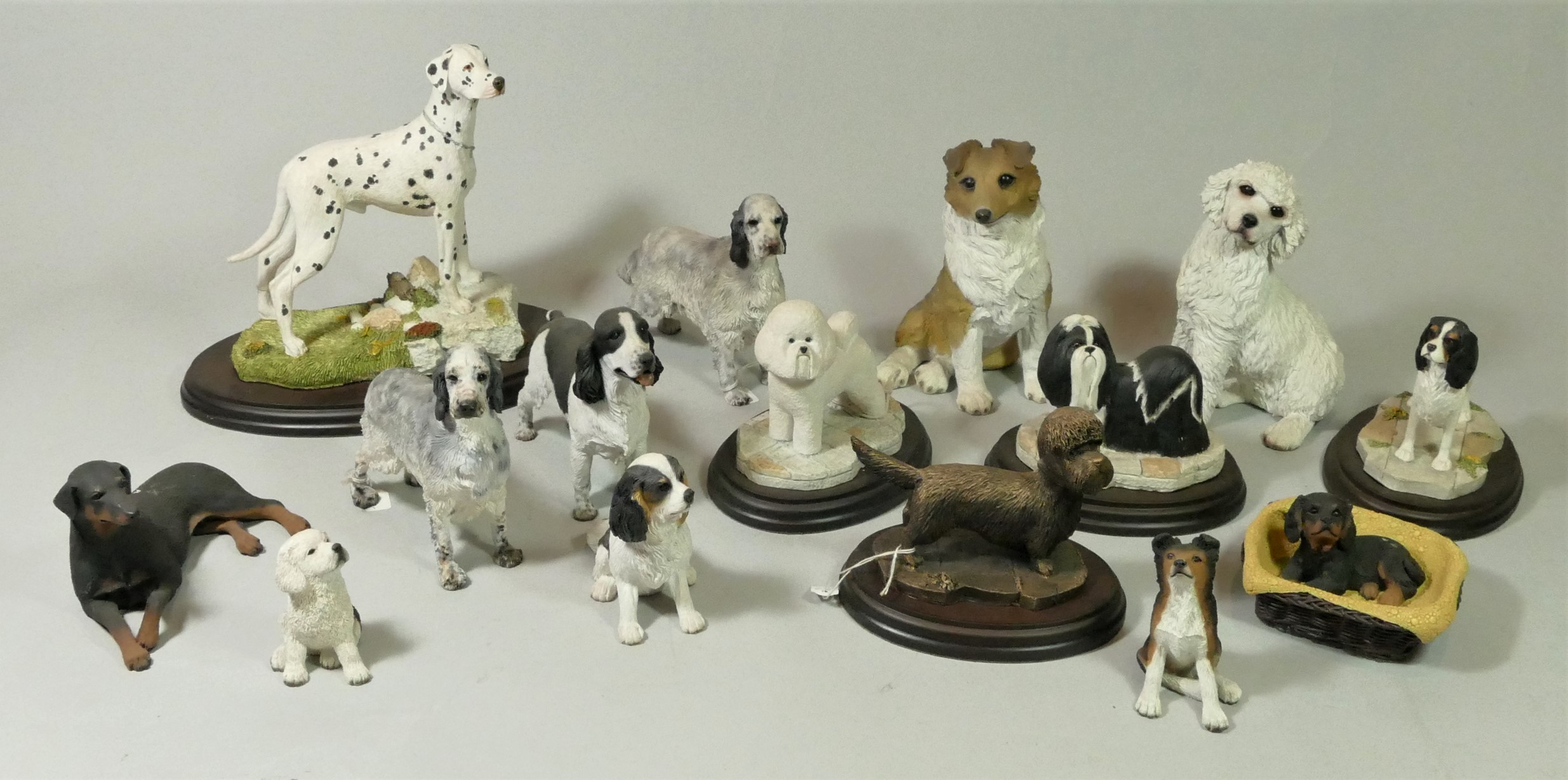 A collection of handcrafted model dogs together with ceramic fruit bowls, glass vases and an early