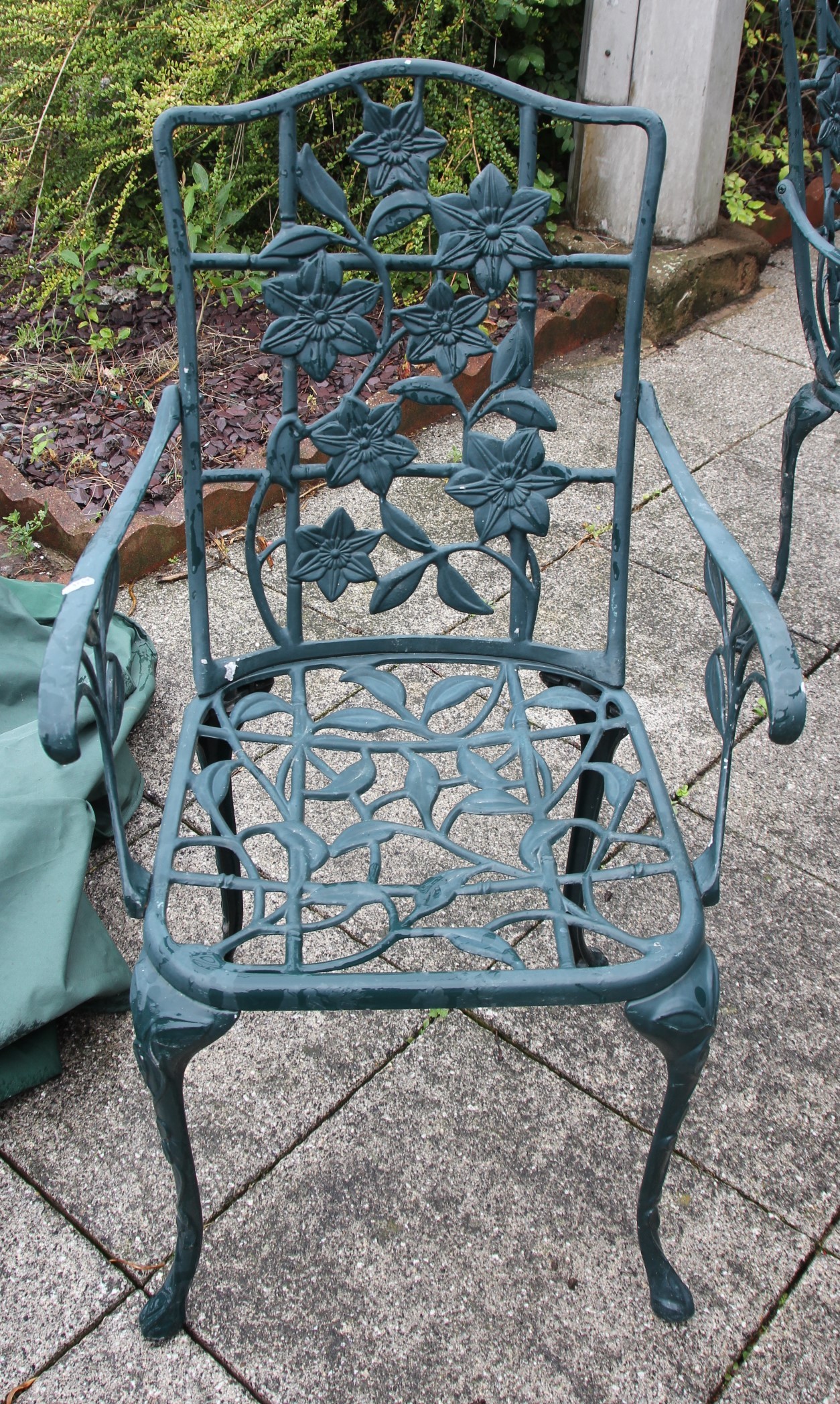 A cast metal garden dining set, painted dark green with floral decoration, with four - Image 3 of 4