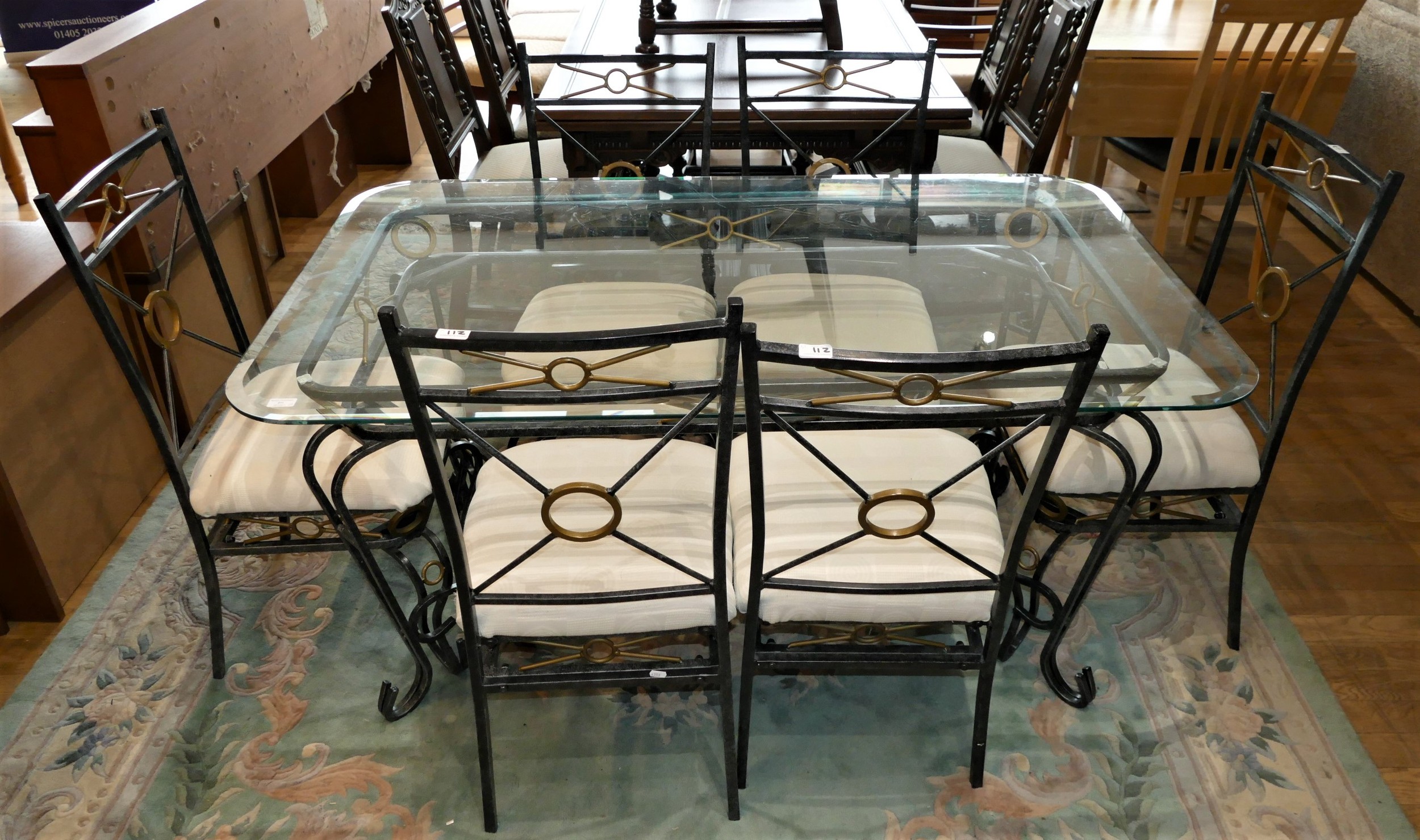 A wrought iron glass top dining table, together with a set of six matching wrought iron dining