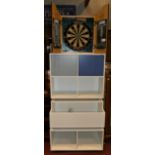 A modern three sectional modular storage unit, together with a 'Phil The Power Taylor' dartboard