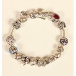 A silver Pandora bracelet with twelve charms and two locking clasps, box