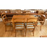 A dining suite comprising of a set of six ladderback chairs (4+2 carvers) with upholstered seats and