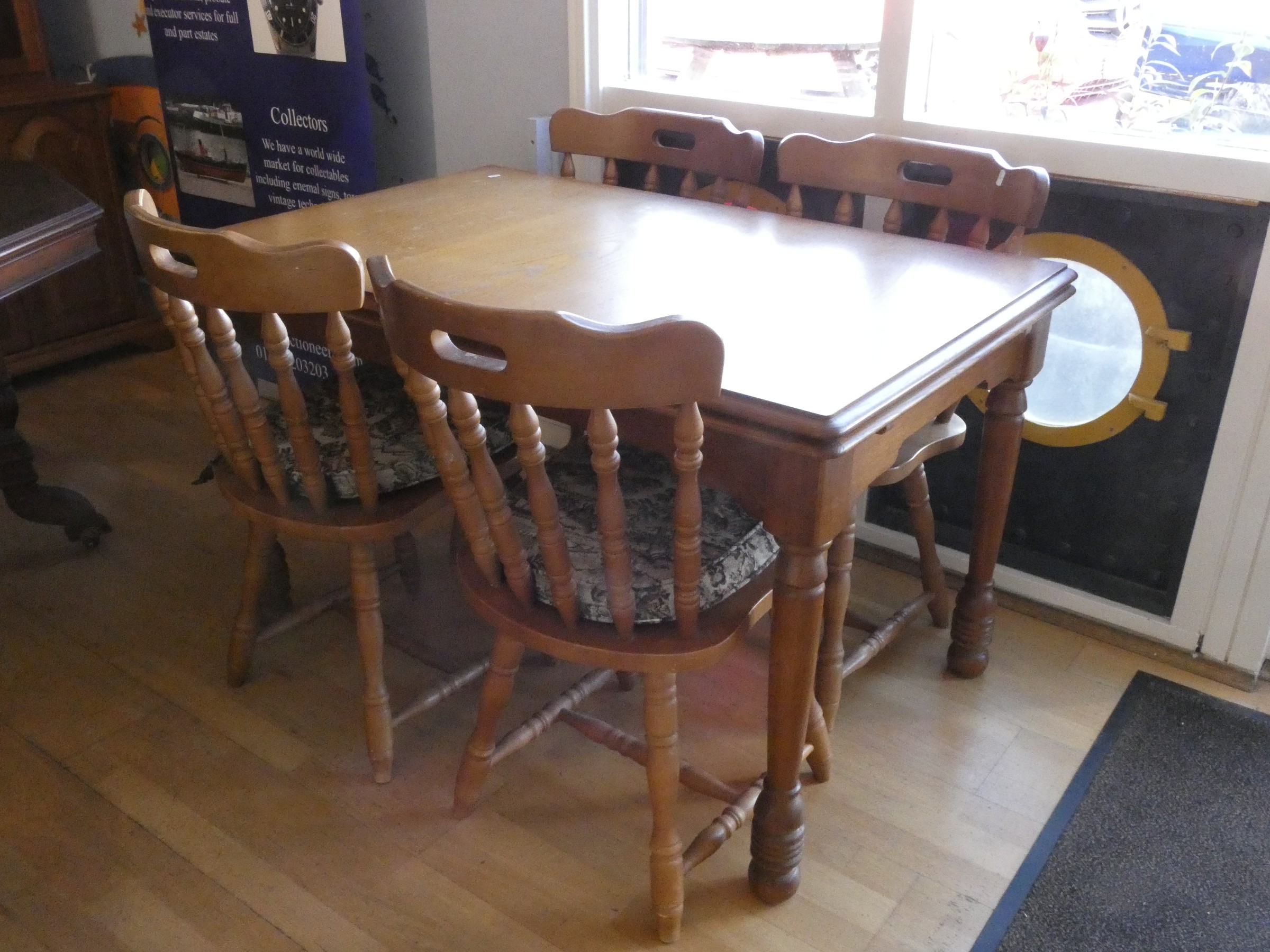 A modern pine dining suite consisting of a draw leaf table and a set of four matching dining chairs.