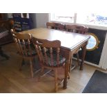 A modern pine dining suite consisting of a draw leaf table and a set of four matching dining chairs.