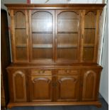 A dresser display cabinet, upper section having three glazed doors to reveal fitted shelves,