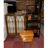 A mid Century walnut veneered display cabinet comprising of two glazed doors, fitted interior with