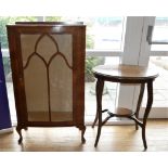 A mid Century floor standing walnut veneered display cabinet, with central glazed door and two