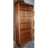 An oak veneered free standing six height open bookshelf unit. H200cm, W84cm, D32cm.