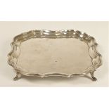 A square silver card tray, by Barker Bros, Chester 1912, raised on four feet, uninscribed, 17ch