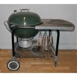 A Webber Deluxe Gourmet charcoal BBQ - 57cm diameter, heavy duty steel trolley with lower wire rack,