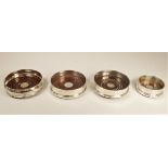 A silver bottle coasters, Birmingham 1998, mahogany base, diameter 12.5cm, another similar Sheffield