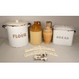 An early 20th Century white enamel flour bin together with a white enamel bread bin, a large Doulton