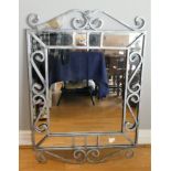 A modern painted cast metal framed bevel edged wall mirror, with scrolled decoration, 95 x 66cm