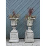 A pair of garden urns on column bases, cast in limestone, height, 115cm (2) These are very heavy