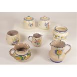 A collection of Poole pottery to include - 1930s floral pattern small jugs, lidded preserve pots,