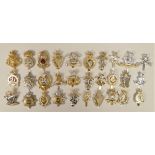 A collection of 30 Staybright and other military cap badges, including Irish, Hussars and Gurkha.