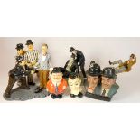 A collection of Laurel and Hardy figures, mostly made from composite plastics and ceramics,