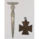 A German WWII metal letter opener, the eagle surmount, 12.5cm and an iron cross (2)