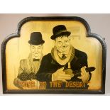 A Laurel and Hardy wall hanging painted sign, depicting a scene from their 1933 film 'Sons of the