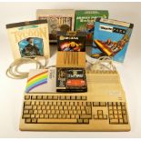 A Commodore Amiga 500, power supply and six boxed programmes, to include Theme Park, Sid Meier's