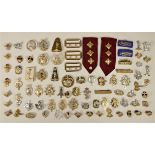 A collection of Staybridge and other military cap, collar and shoulder badges.