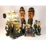 A collection of Laurel and Hardy figures, mostly made from composite plastics and ceramics,