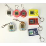 Eight key chain games, to include : Three Tamagotchi's by Bandai Three Electronic Pet by Bandai