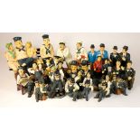 A collection of Laurel and Hardy figures, mostly made from composite plastics and ceramics,