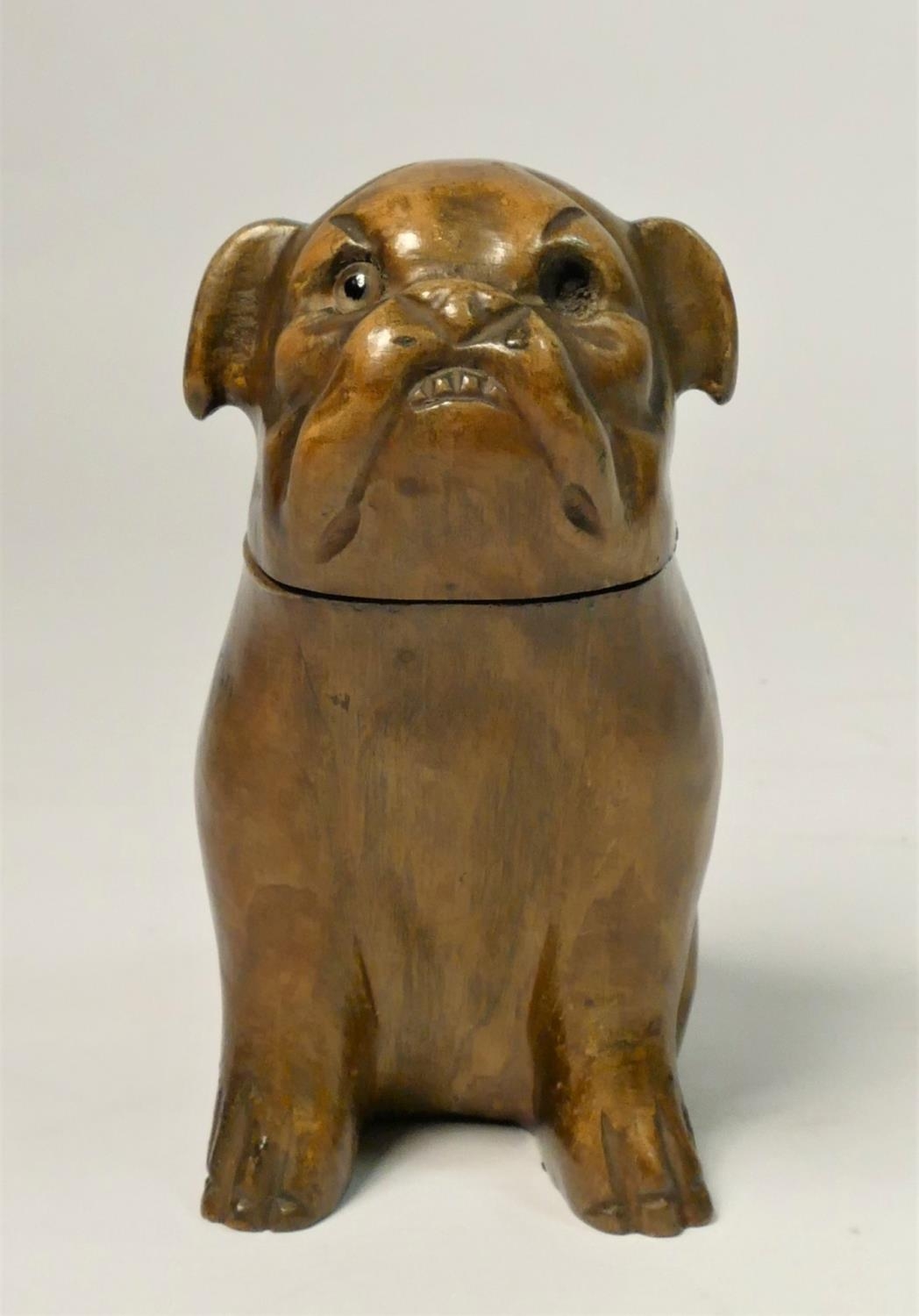 A novelty inkwell, in the form of a soft wood Bulldog, opening to reveal inkwell, missing one