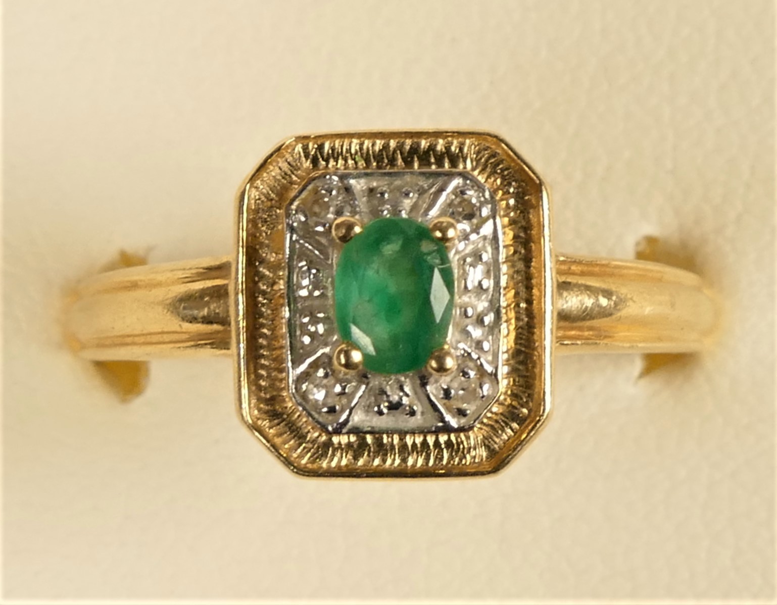 A 14ct gold emerald and diamond cluster ring, T, 2.9gm
