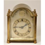 An arched brass manual wind carriage clock, striking with Roman numeral dial, 15 x 12 cm