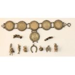 A silver mounted one shilling bracelet, 1936-1940 and several silver charms