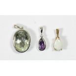 A 9ct white gold amethyst and diamond pendant, an opal pendant and another pendant