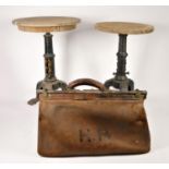 A Victorian/Edwardian leather Gladstone bag initialled H.R.P together with, two cast iron