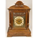 An Edwardian oak chiming and striking mantle clock, the gilt dial with silvered chapter ring, the