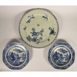 A Chinese late Qing dynasty blue and white pair of octagonal plates, decorated with buildings and