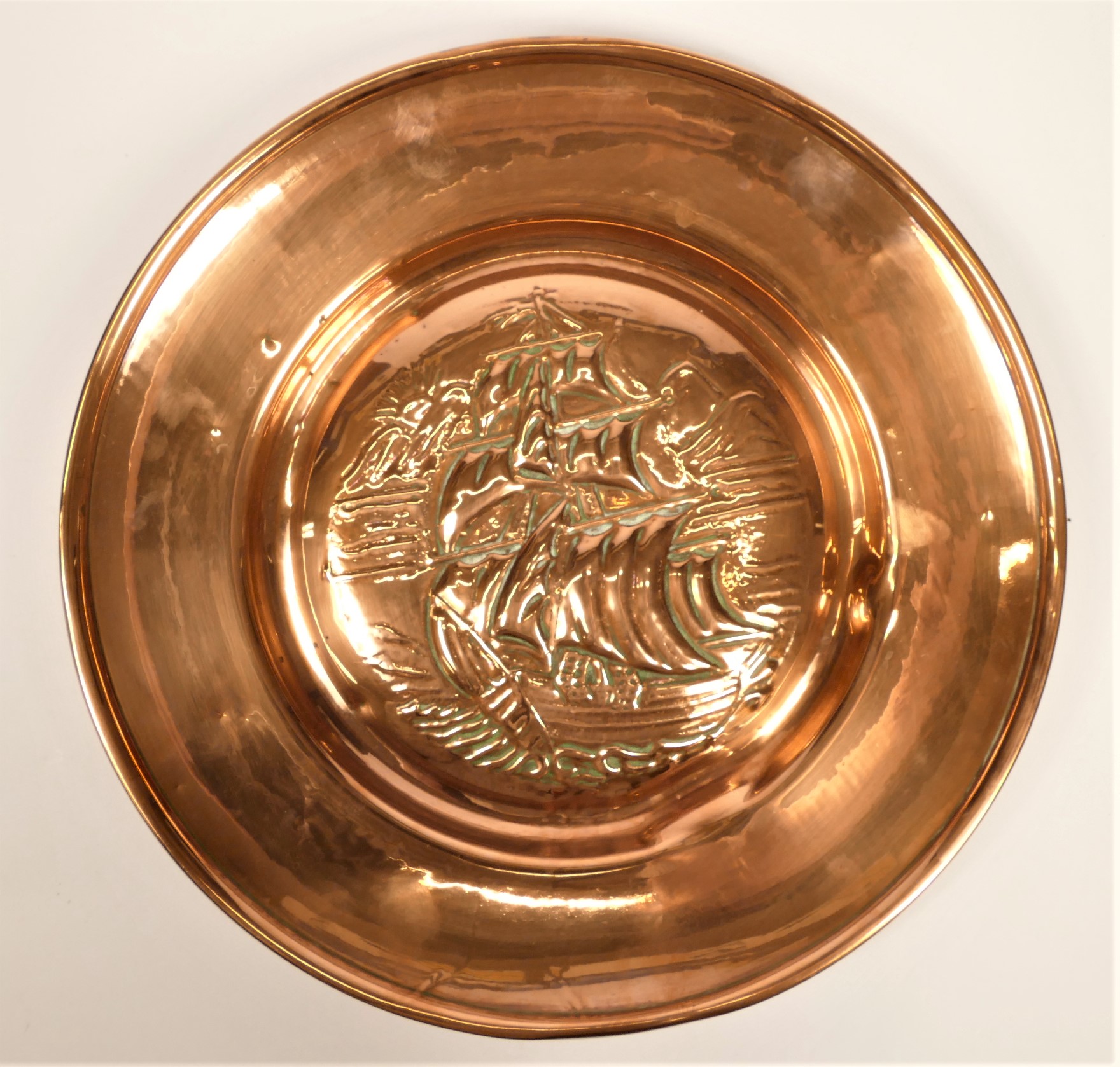 Newlyn School, an Arts and Crafts embossed copper charger, decorated with a galleon, plain fold over - Image 2 of 2