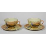 A pair of Locke & Co, Worcester cups and saucers, decorated with peacocks by J. Lewis, pattern 361.