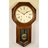 Ansonia Clock Co., an American mahogany drop dial wall clock, the 11 1/2" white enamel dial with