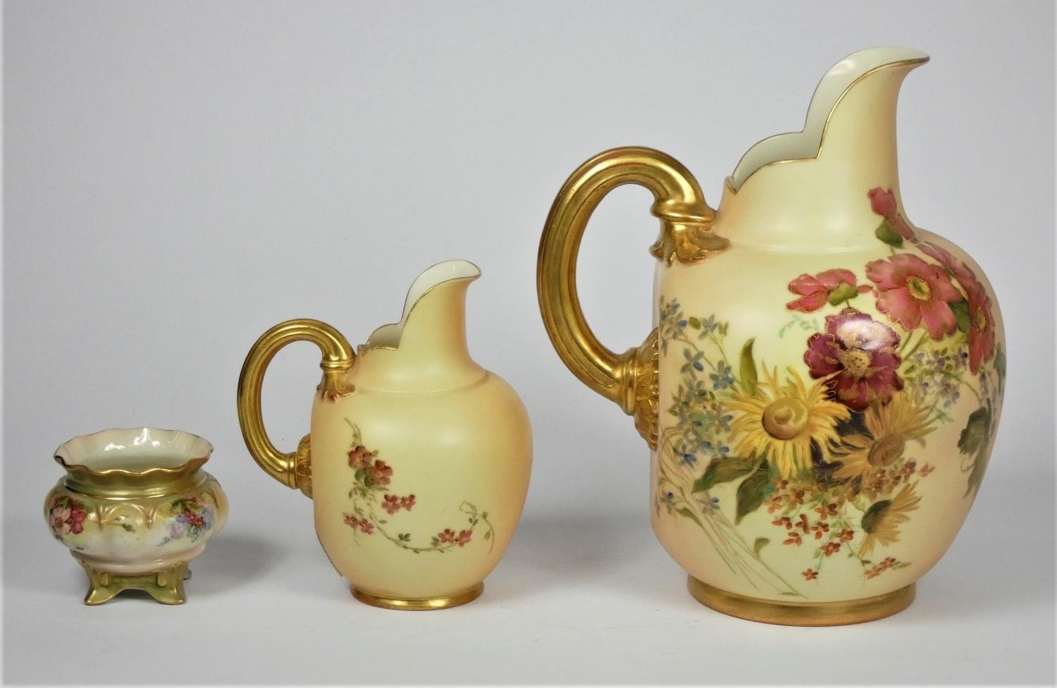 A Royal Worcester porcelain ewer, model 1094, c.1902, painted with flowers on a blush ivory