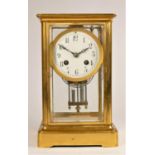 A French brass four glass mantle clock, the white enamel dial with Arabic numerals, the movement