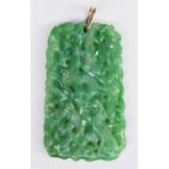 A Chinese green jade pendant, late Qing/Republic period, carved and pierced with birds amongst
