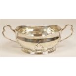 A silver two handled porringer, by William Comyns, London1912, with cut card decoration, 19cm across