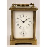 A brass alarm carriage time piece, the white enamel dial with Roman numerals, subsidiary alarm dial,
