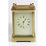 A brass 1/2 hour striking carriage clock, white enamel dial with Roman numerals, unsigned movement