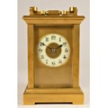 A French brass 1/2 hour striking carriage clock, the off white dial with Arabic numerals, the